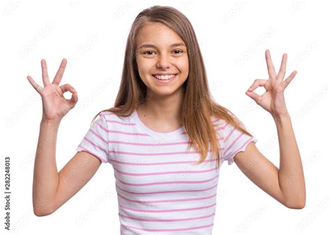 Portrait Of Teen Girl Making Ok Gesture Isolated On White Background