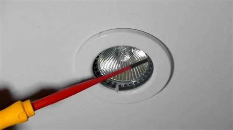 Not all ceilings are flat. How to change a 12v halogen downlight bulb in a metal ring ...