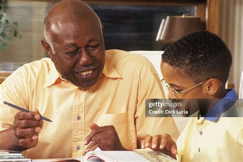 African American Father And Son Doing Homework Foto De Stock Getty Images