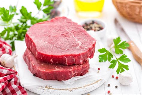 Raw Uncooked Beef Meat Steaks On White Wooden Background Stock Image
