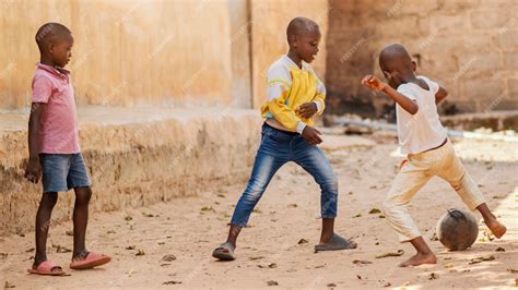 Free Photo Full Shot African Kids Playing With Ball