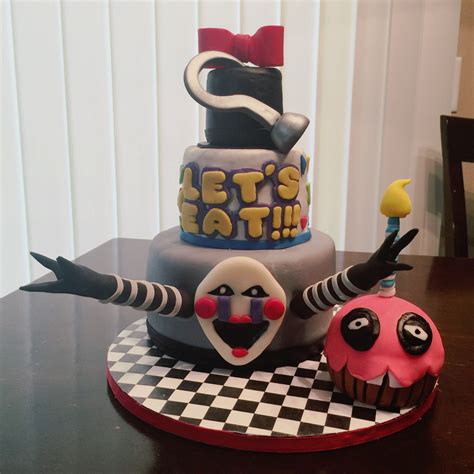 There Is A Cake With Clowns On It And The Words Lets Eat