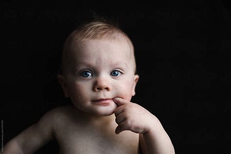 Portrait Of A Sweet Baby Sucking His Finger By Stocksy Contributor