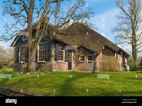Typical Dutch Country House With Straw Roofing In Giethoorn The