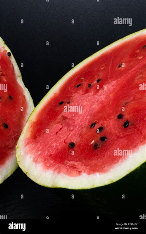 Delicious Watermelon Cut In Halves Isolated On Black Background With