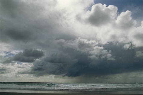 Dramatic Storm Clouds Over Ocean Water Photograph By Charles Kogod