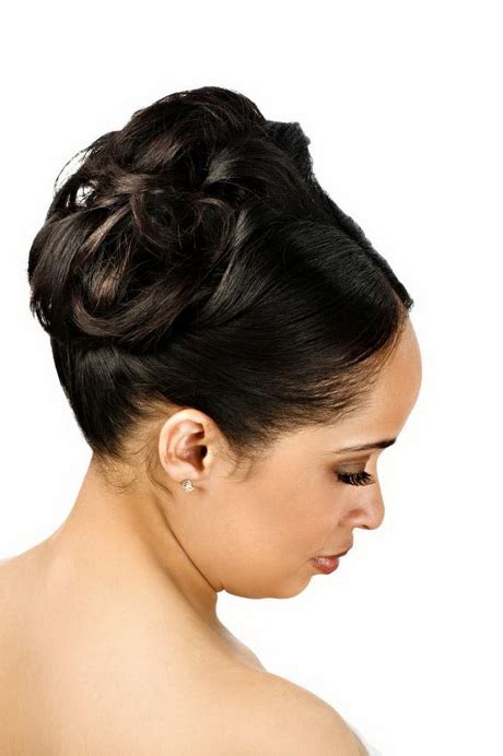 Blow out and straighten natural hair, then curl the ends slightly before separating into sections and pinning into place. Black wedding hairstyles updos