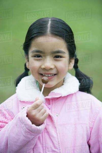 Girl Holding Lollipop Portrait Stock Photo Dissolve
