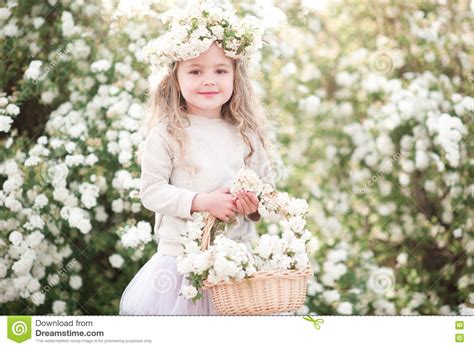 These photos of flowers are so stunning. Cute Baby Girl With Flowers In Garden Stock Photo - Image ...
