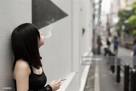 Young And Beautiful Asian Woman Smoking In The City High Res Stock