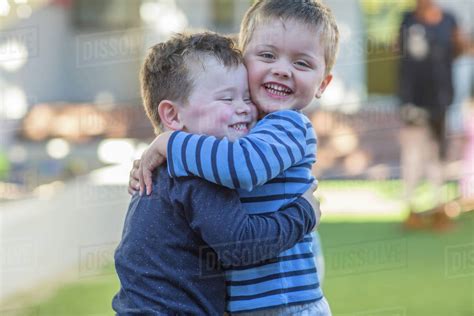 Two Young Boys Outdoors Hugging Stock Photo Dissolve