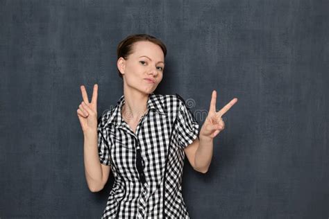 Portrait Of Happy Young Woman Showing Victory Or Peace Gestures Stock