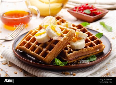 Homemade Crispy Belgian Waffles Served With Banana And Honey Stock