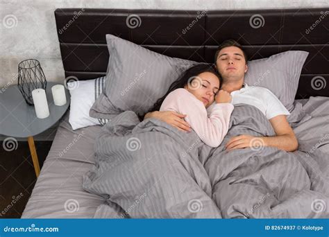 Portrait Of Attractive Young Couple Hugging Each Other While Sleeping