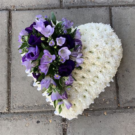 Striking White Based Heart Shape Funeral Flowers Tribute With Lilac