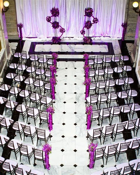 Tables featured alternating high and low centerpieces of blush and ivory blooms. Purple And White Decoration For Wedding