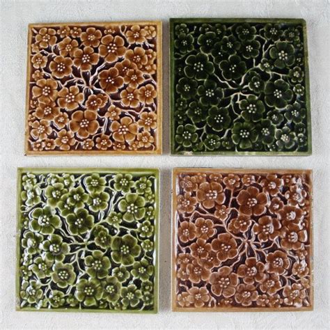 Four Square Tiles With Flowers On Them Are Shown In Three Different
