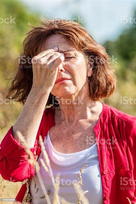 Gorgeous Mature Woman With Freckles Suffering From Hot Flashes Outdoors