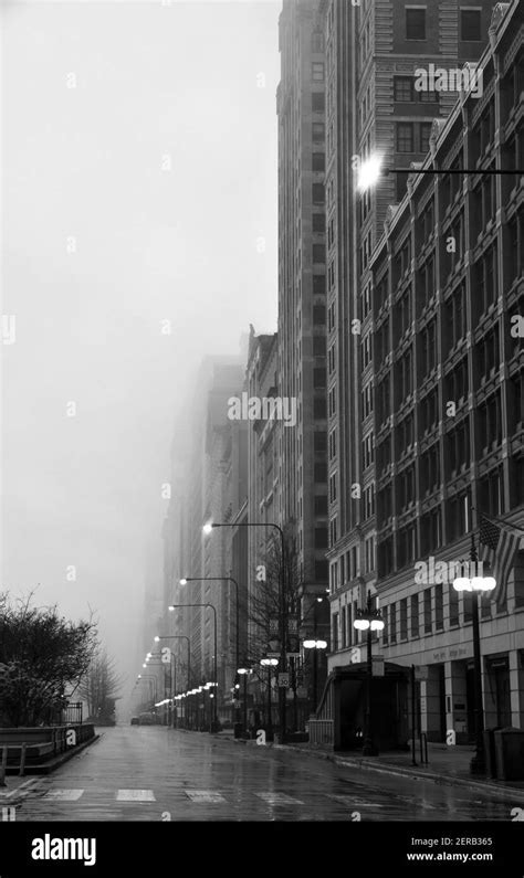 Empty City Street With Tall Buildings On A Foggy Morning Stock Photo