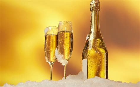 Champagne Glasses And A Bottle Of Champagne Snow Golden Background