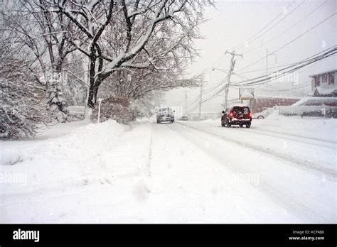 Snow Plows Work Hard To Clear Deep Snow On Roads Following A Blizzard