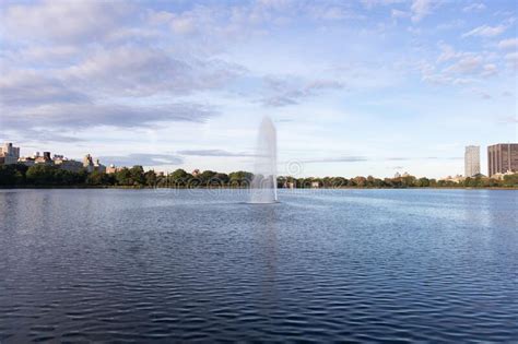 Central Park Reservoir And Fountain With A Blue Sky In New York City