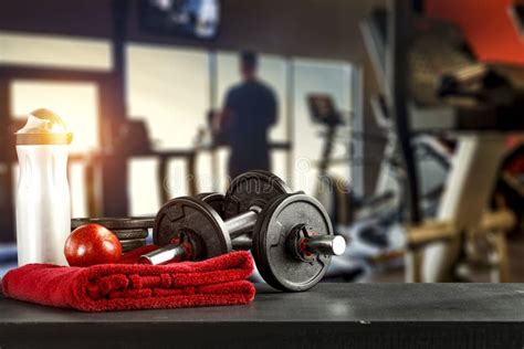 Dumbbell Barbell On Red Towel Table Workout In The Gym Space For