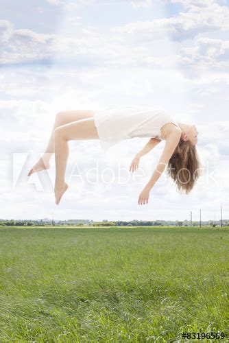 Young Beautiful Woman Floating Towards The Sky Stock Photo And