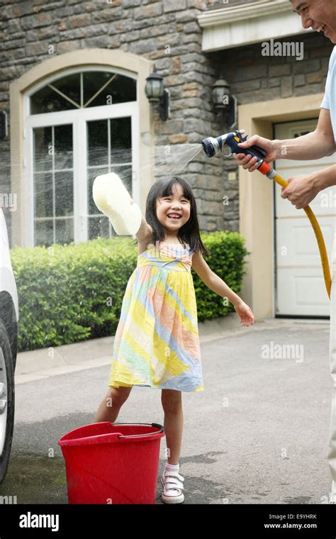 Girl Helping Father Cleaning Car Stock Photo Alamy