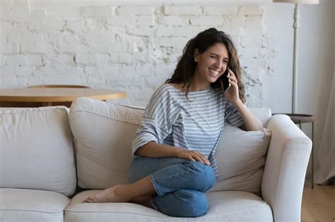 Joyful Happy Young Adult Hispanic Woman Talking On Cellphone Stock