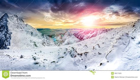 Panoramic View Of White Winter Mountains At Colorful Sunset Stock Image