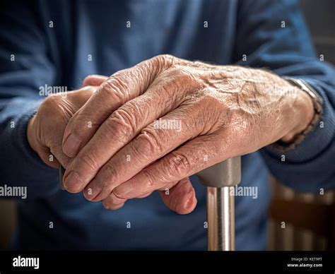 Old Mans Hands Resting On Walking Stick Stock Photo Alamy