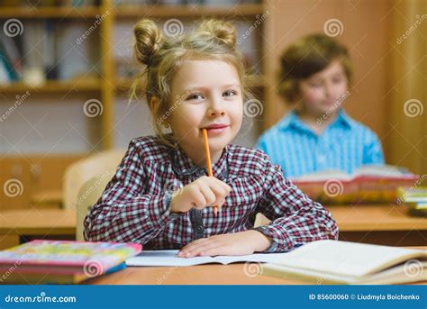 Children Learning And Doing Homework In School Classroom Stock Photo