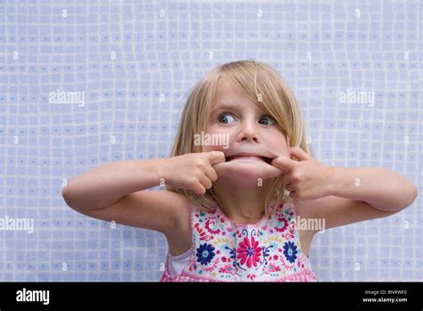 Little Blonde Girl Making A Funny Face Stock Photo Royalty Free Image