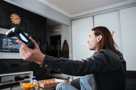 Side View Image Of Young Sad Man Gamer Sitting At Home Stock Image