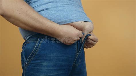 Heavy Man Trying To Fasten Jeans Pants Under A Fat Stomach The Problem