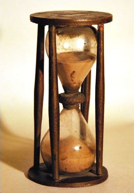 a late 18th century country made hourglass approx 30 minute duration 6 inches in height 11