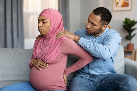 loving husband making massage to his pregnant black muslim wife at home stock image image of