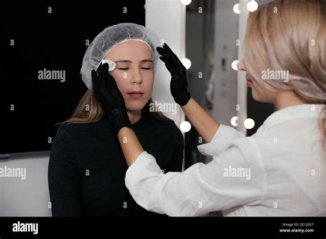 Permanent Makeup Artist In Black Gloves Prepares The Clients Face With