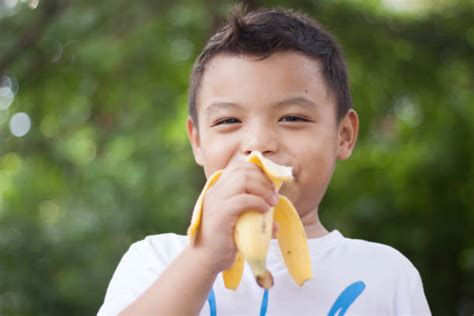 Kid Eating Banana Outside Stock Photos Pictures And Royalty Free Images