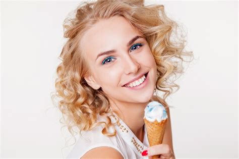 Premium Photo Woman With Curly Hair And Perfect Smile Eating Blue Ice