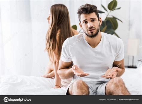 Young Frustrated Man Having Sexual Problems While Sitting Bed Next