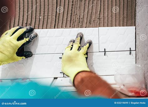 Renovation Close Up Details Hands Of Worker Installing Ceramic Tiles