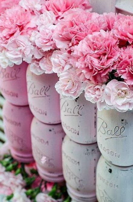 Pink Flowers Are In Mason Jars Lined Up