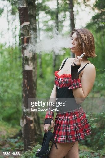 Beautiful Woman Smoking Electronic Cigarette While Holding