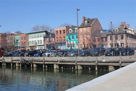 Cars Are Parked Along The Water In Front Of Some Buildings