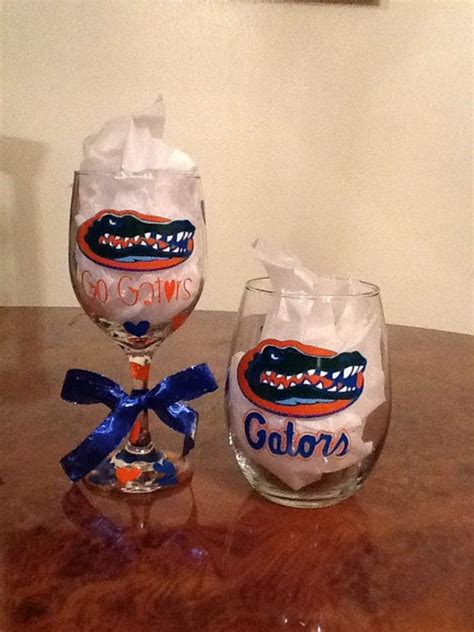 Two Florida Gators Wine Glasses On A Table With A Blue Ribbon Tied Around Them