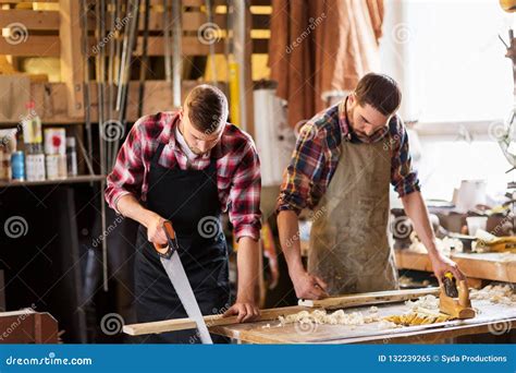 Carpenters Working With Saw And Wood At Workshop Stock Image Image Of