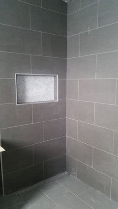 For proper bonding, medium bed mortar should be used in installing fit perimeter tiles in each grid last, leaving 1/4 gap between tile and wall. How to lay rectangular floor tiles?