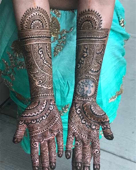 two hands with henna designs on them